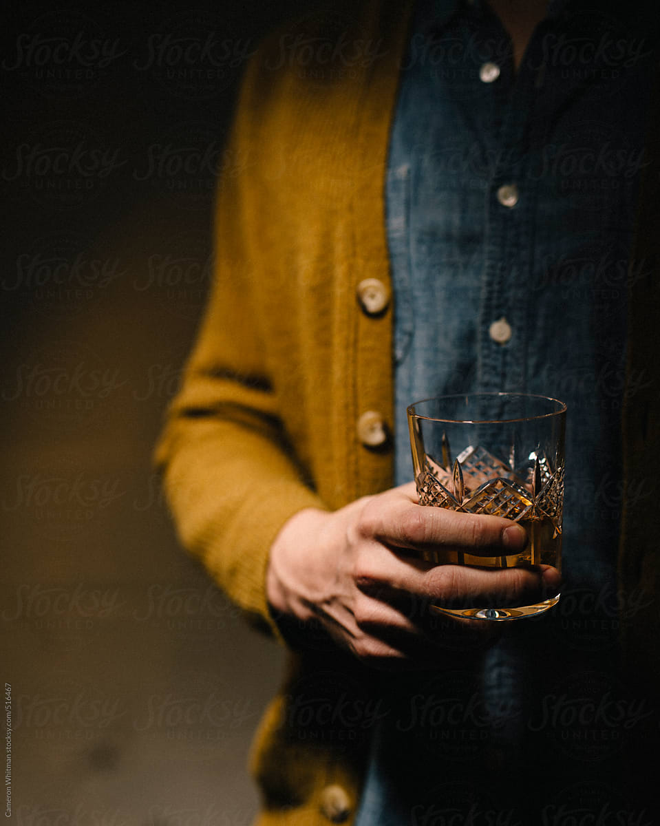 Somber man with a glass of whiskey