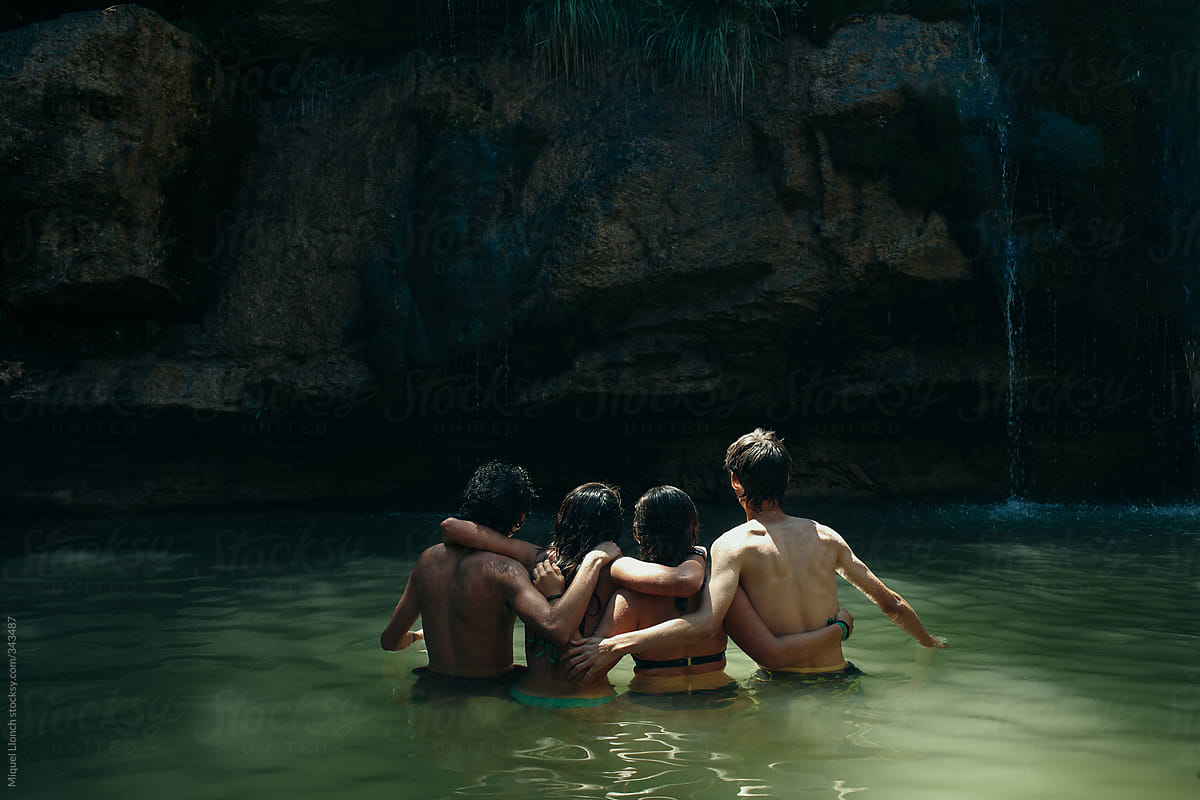 Bunch of friends hugging in a pond