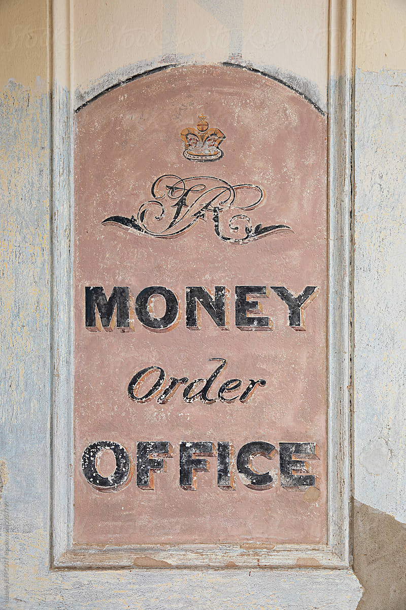 Old hand painted and weathered sign from closed old shopfront