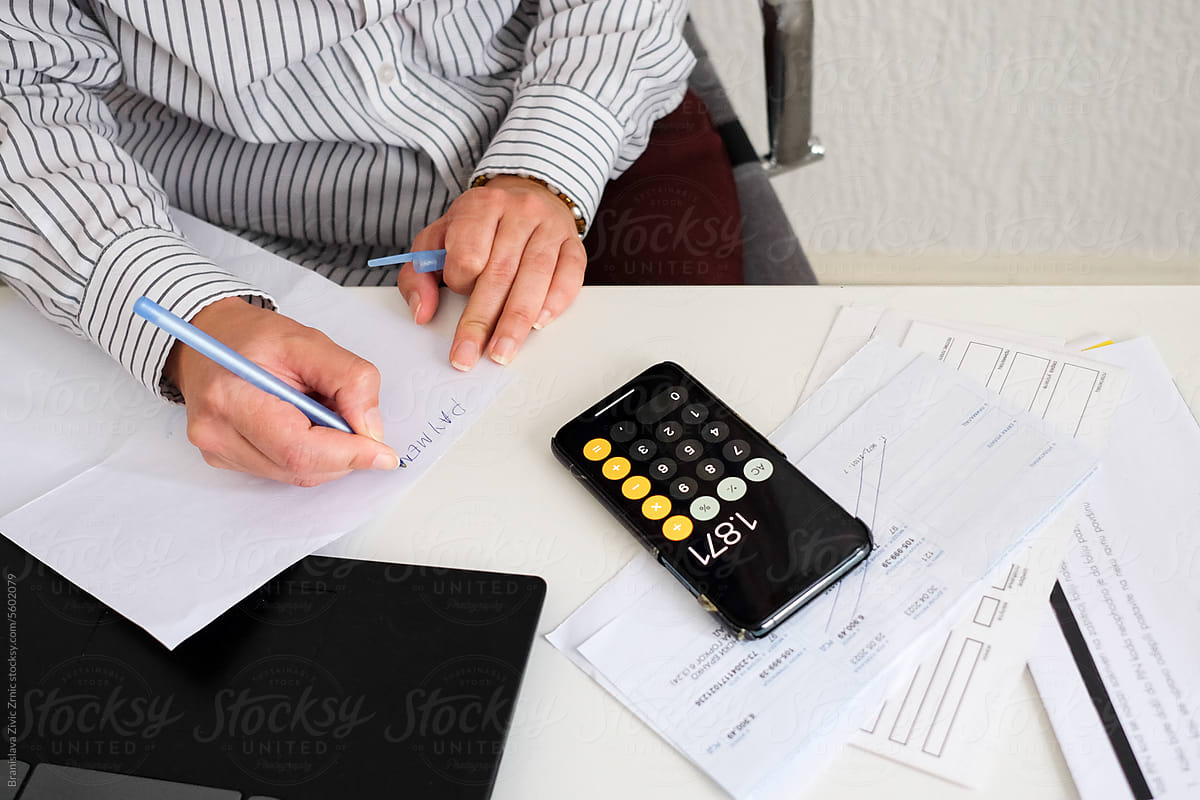 Woman paying utility bills from home calculating expenses
