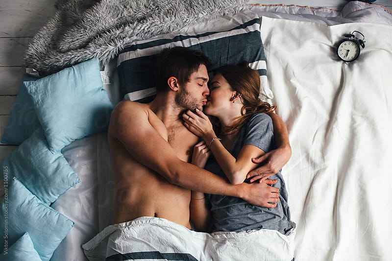 Young sensual couple lying in bed together
