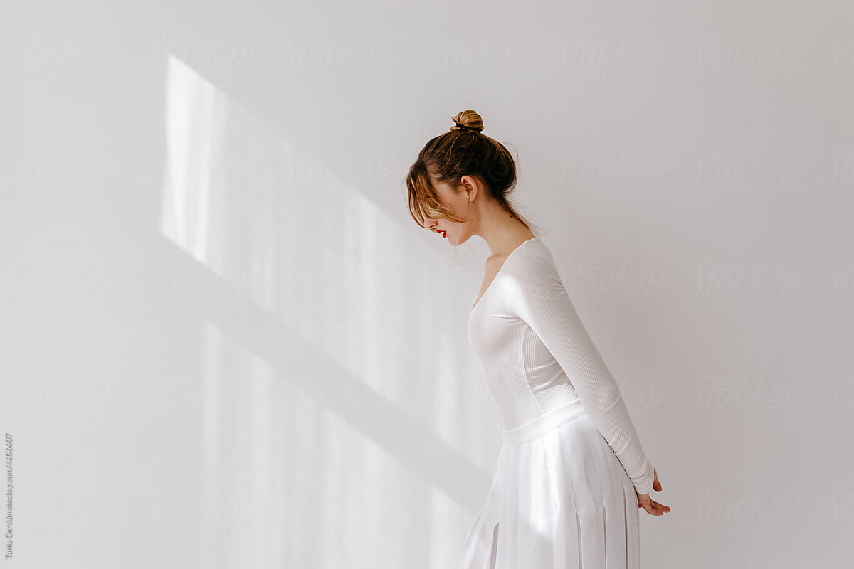 Woman in white dress stepping forward