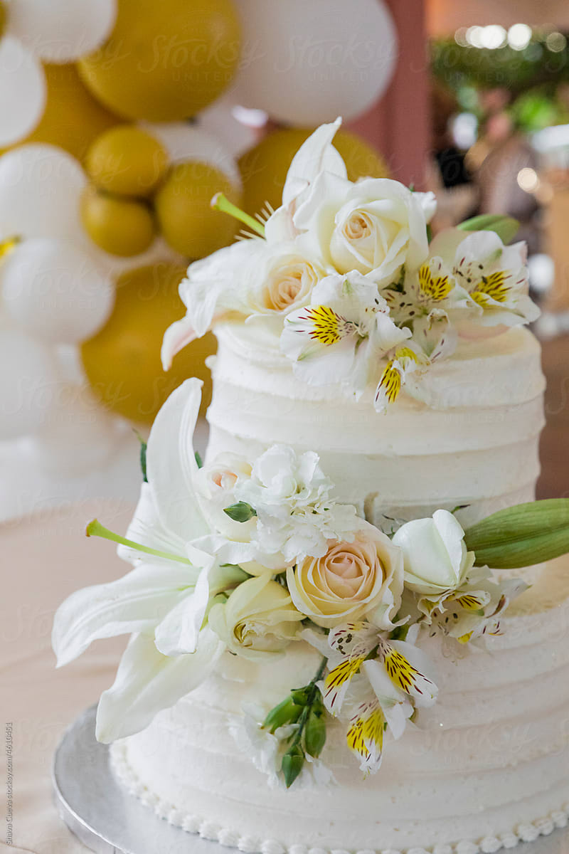 Wedding cake with flowers and a balloons on the background
