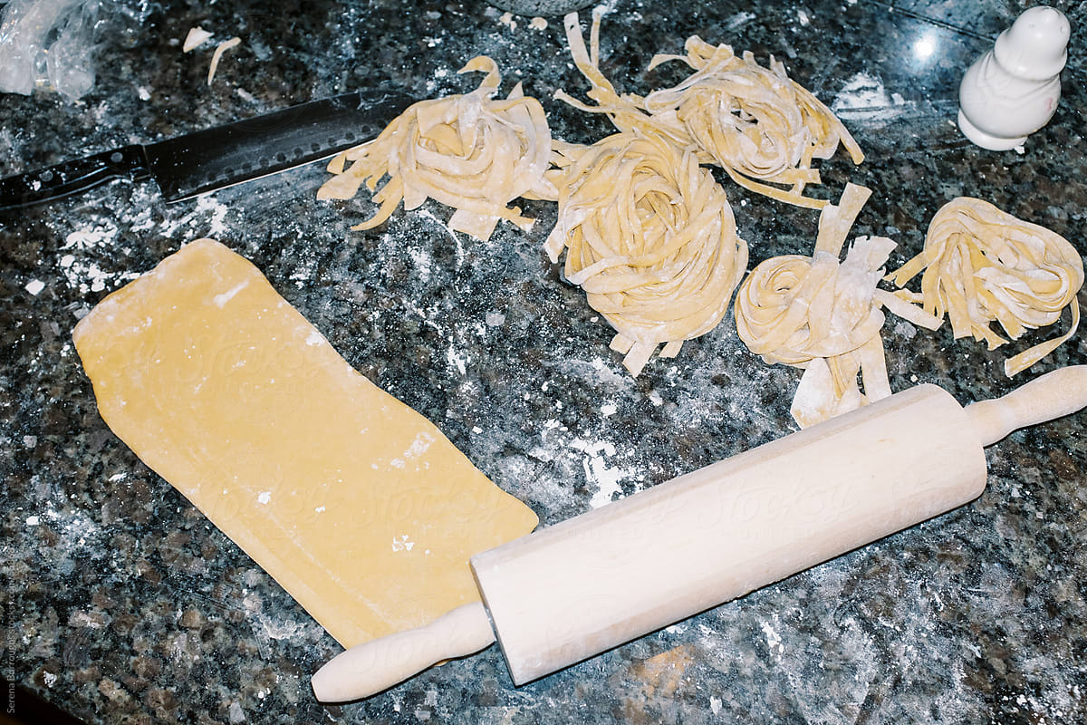 lo-fi flash image of pasta being made on counter