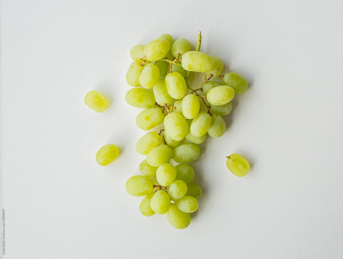 A top-down shot of a bunch of green grapes