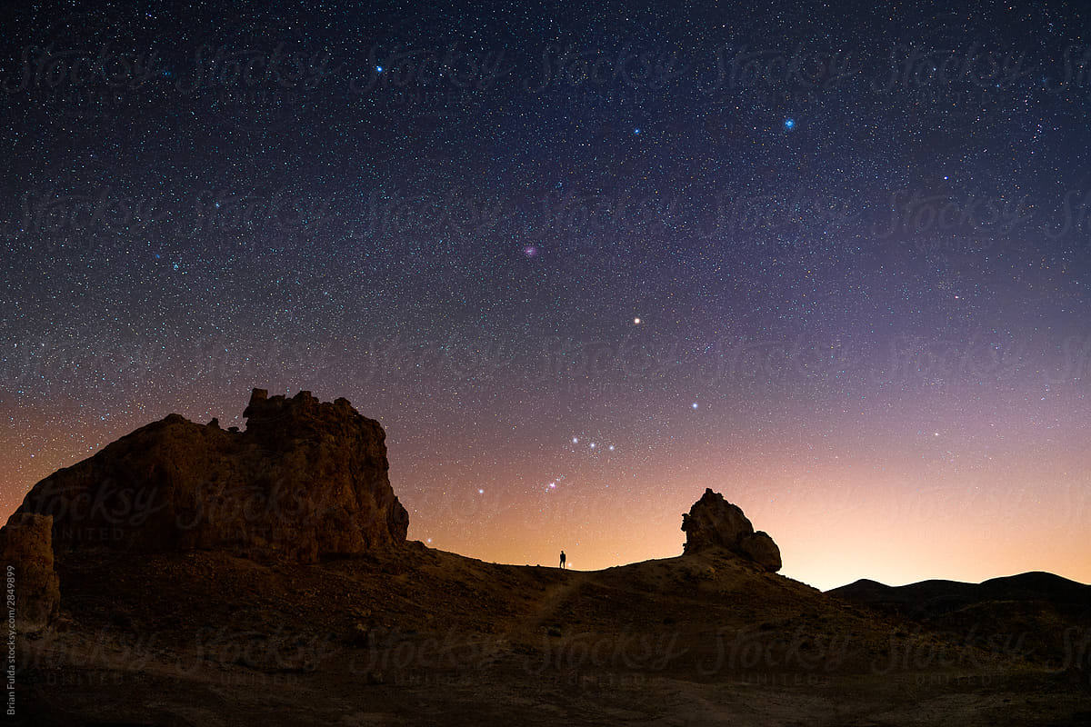Man Standing Under the Winter Stars in the Desert