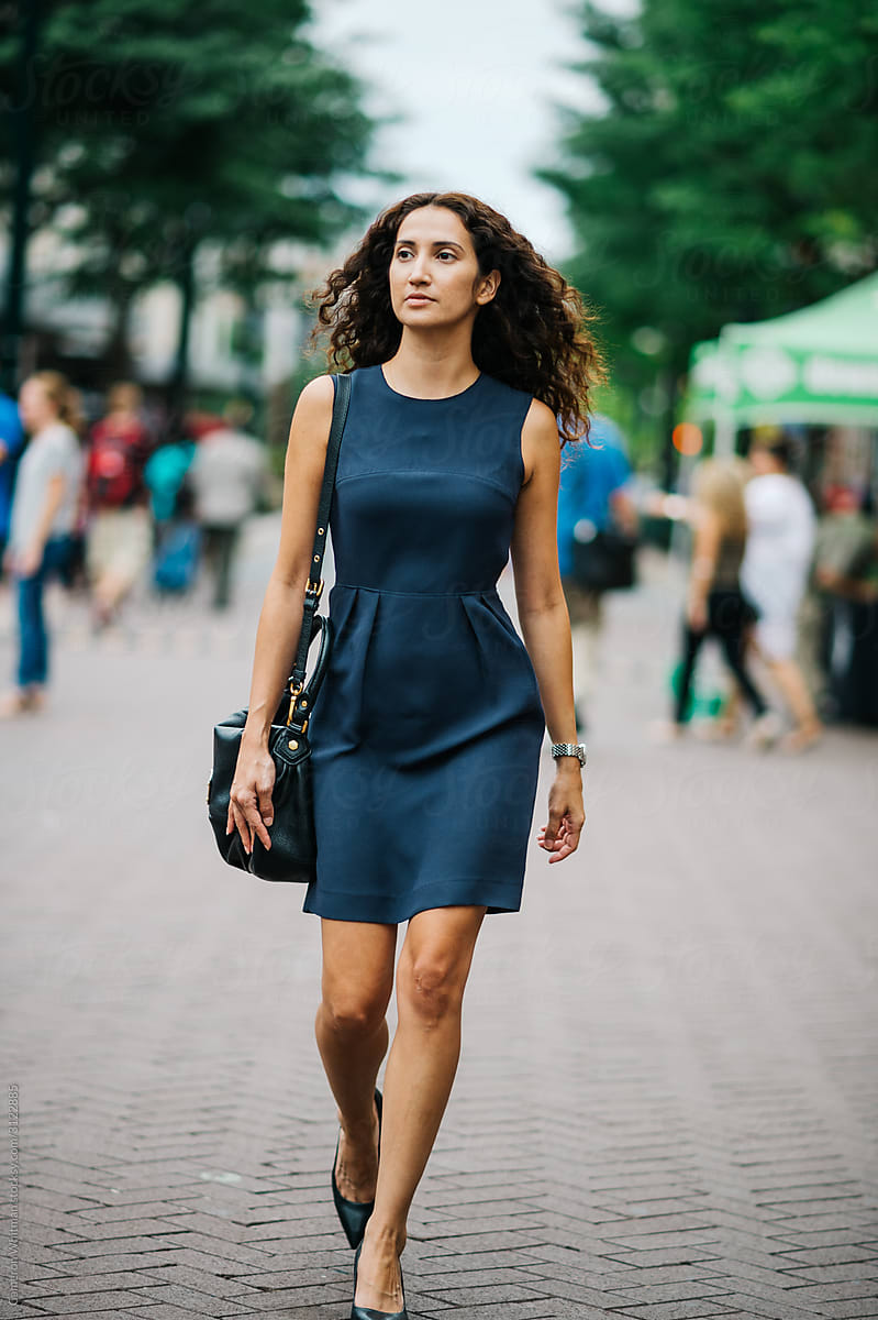Fashionable Young Woman Walking Through Outdoor Market