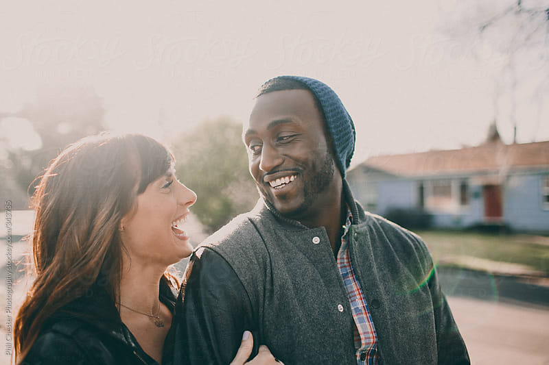 Cute Interracial Couple Walking In Neighborhood By Phil Chester Photography Stocksy United