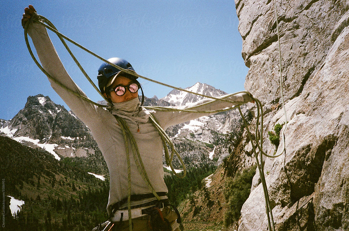 Women preparing her rope for outdoor climbing.