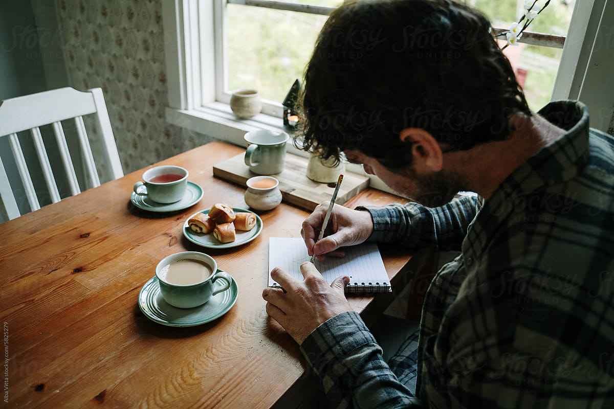 Man writes with coffee