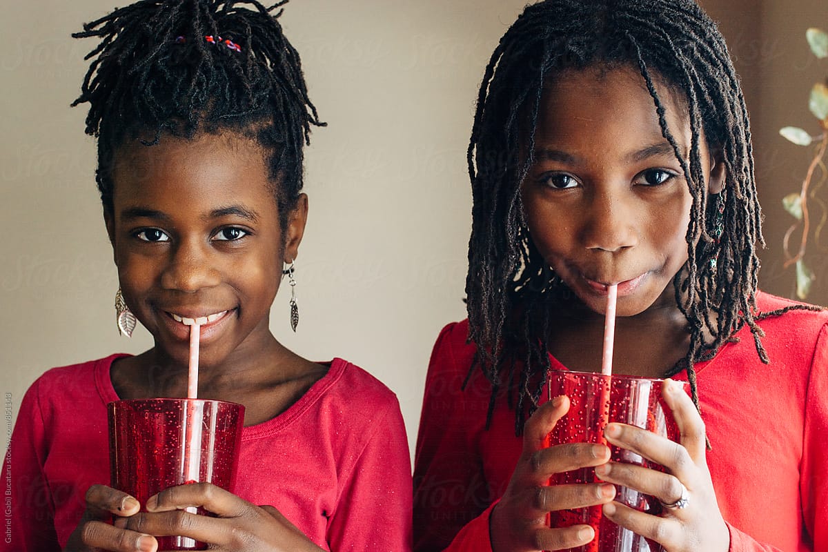 Cute Black Girls In Red Outfits Drinking Juice By Stocksy Contributor Gabi Bucataru Stocksy
