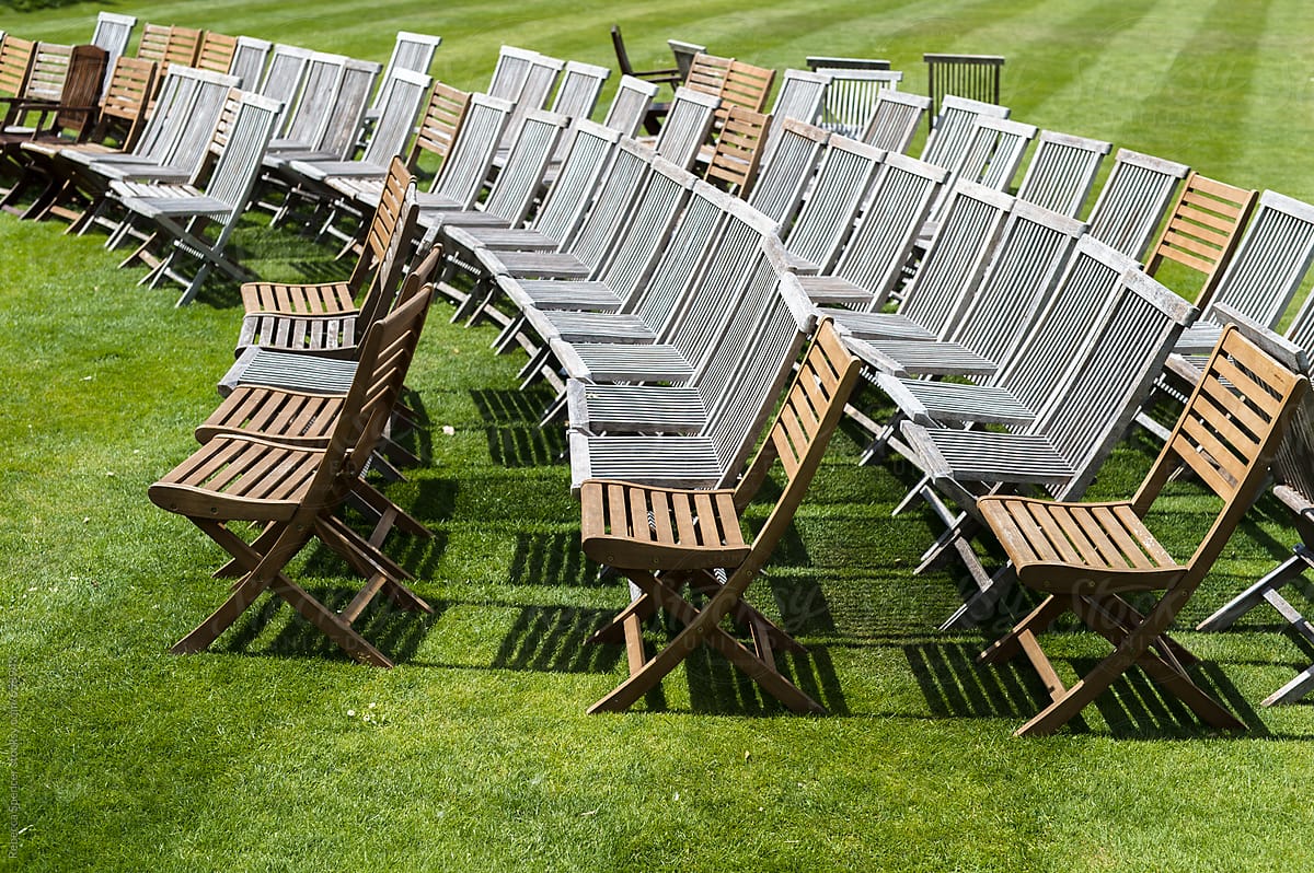 Empty wooden chairs on lawn