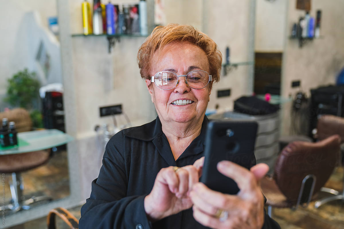 Senior Woman Taking a Photo at the Hairdresser Salon