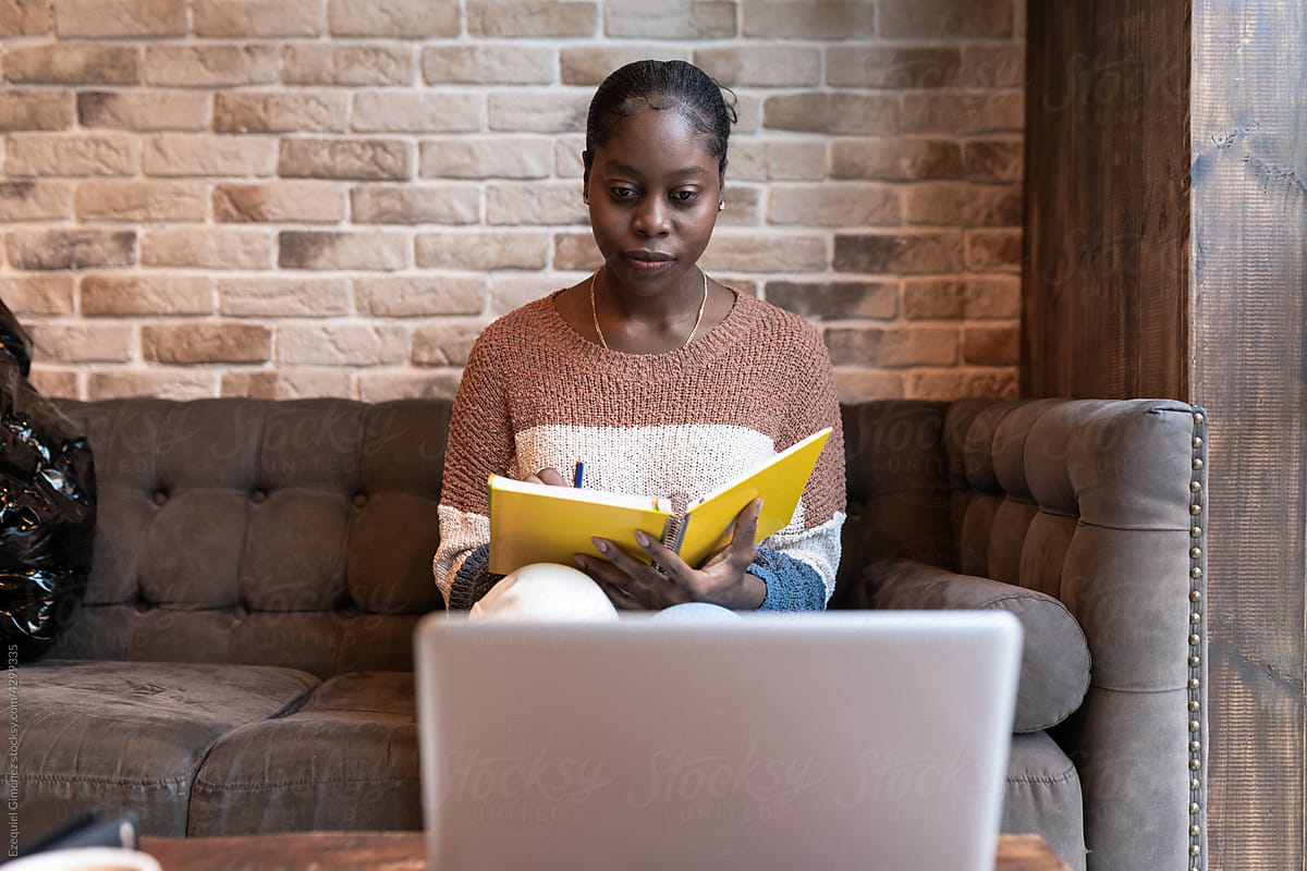 Woman writing notes during studies