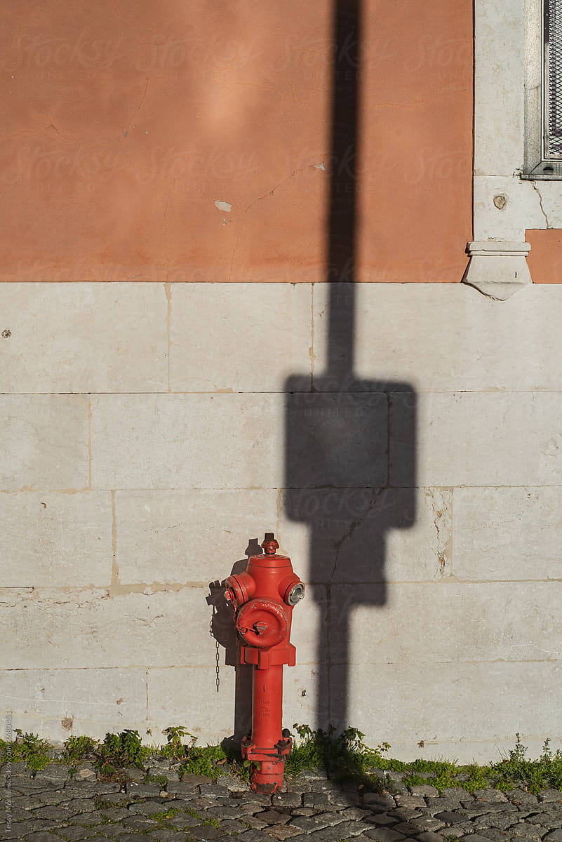 Urban architecture with a red element and a hard shadow