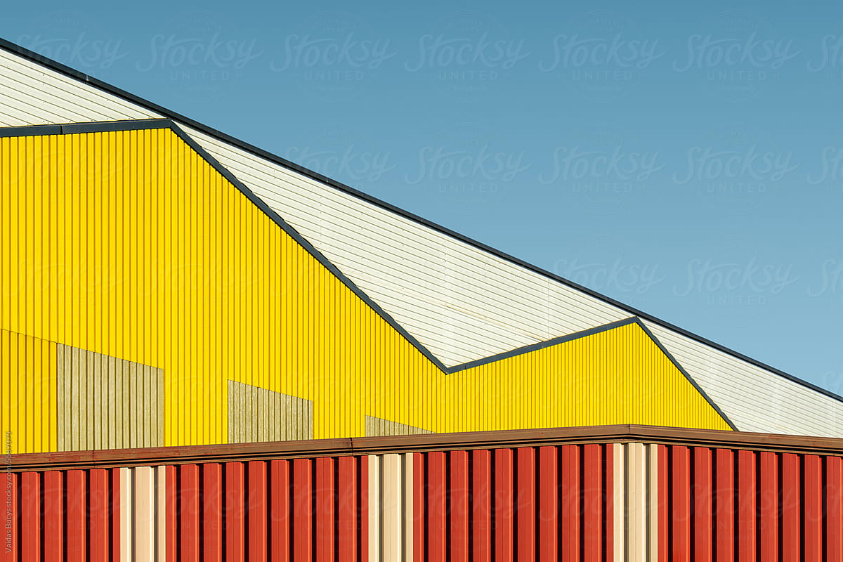 Colorful geometric industrial buildings against blue sky