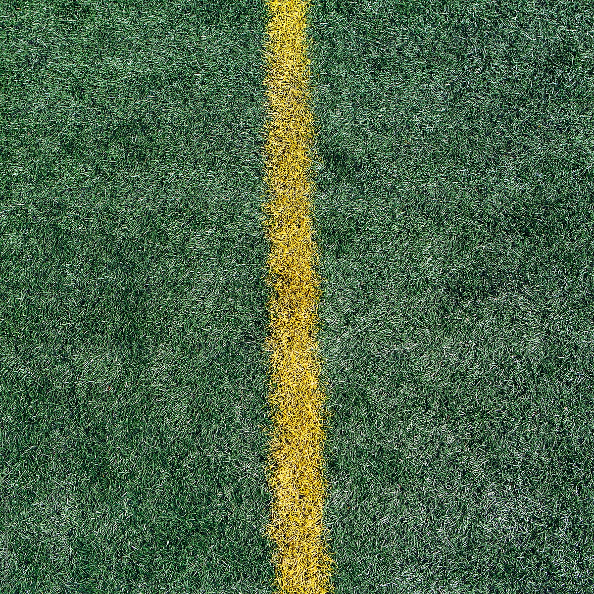 Yellow boundary line on artificial turf sports field