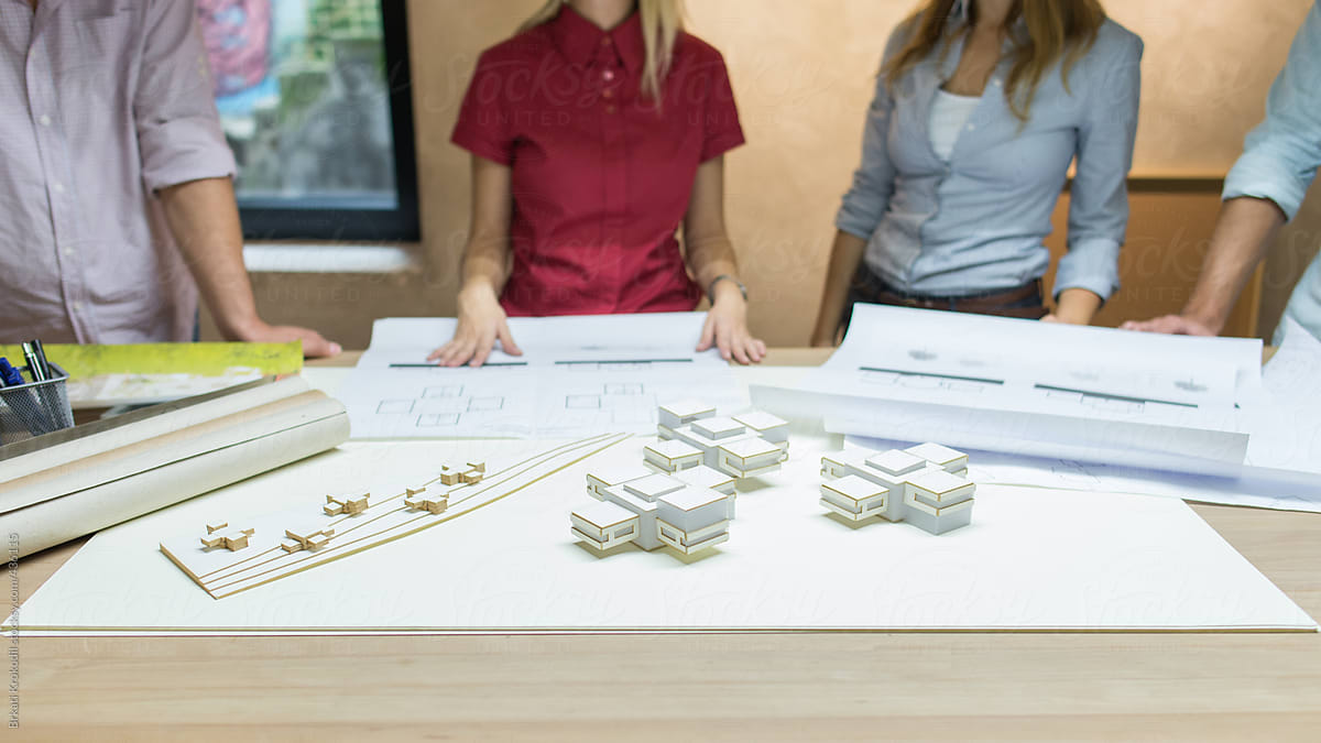 Group Of Anonymous People Working On  Architectural Scale Models