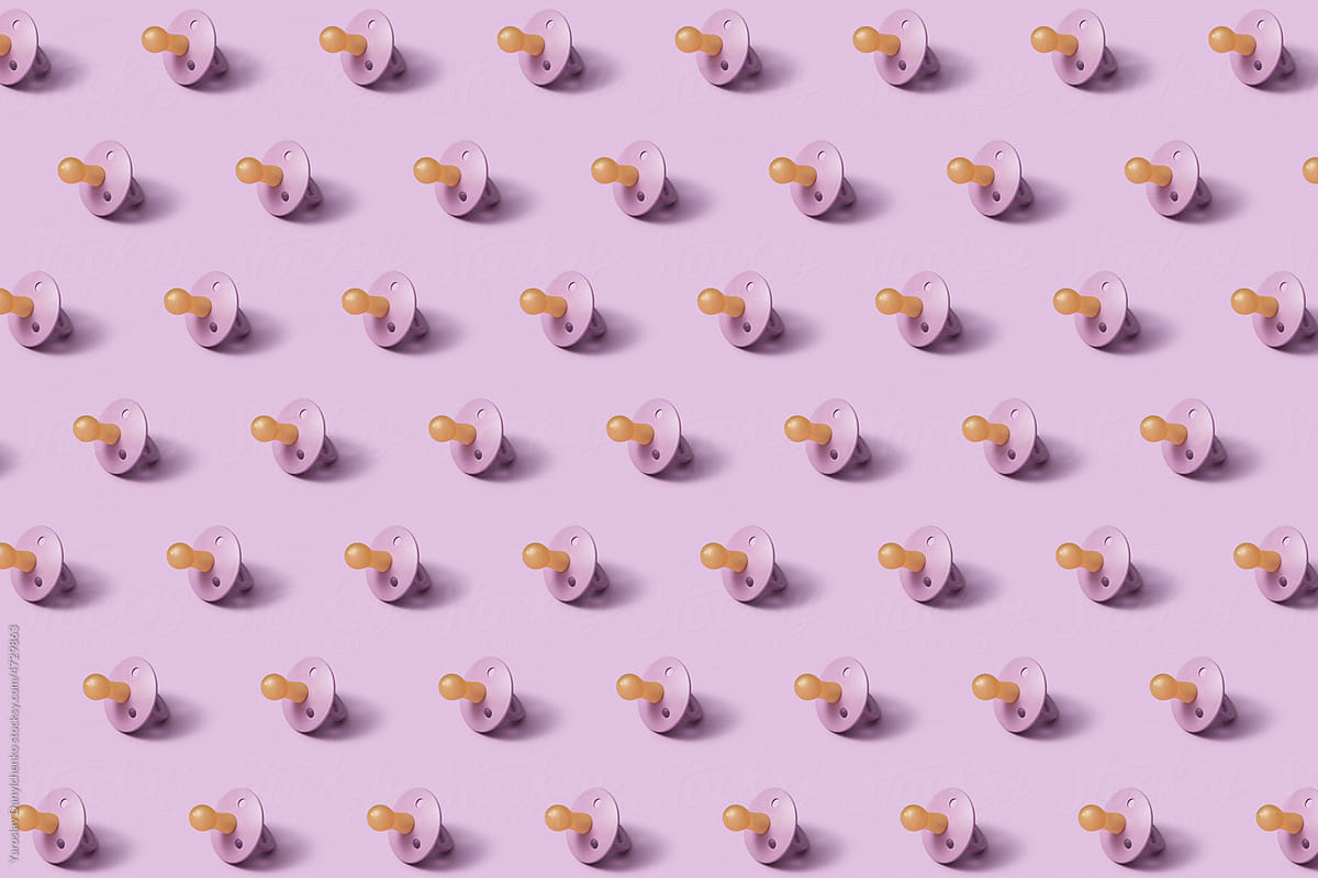 Pattern of baby pacifiers on pink background.