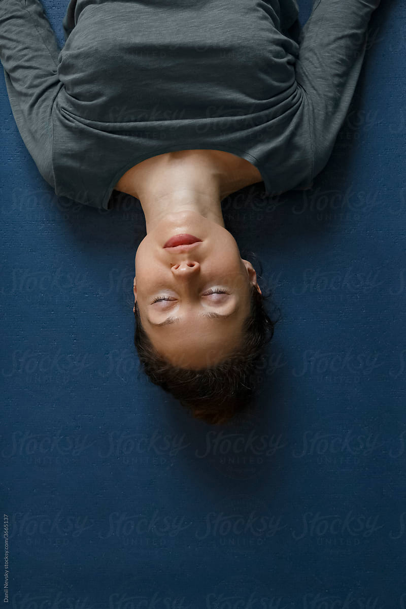 Woman resting on floor during yoga session