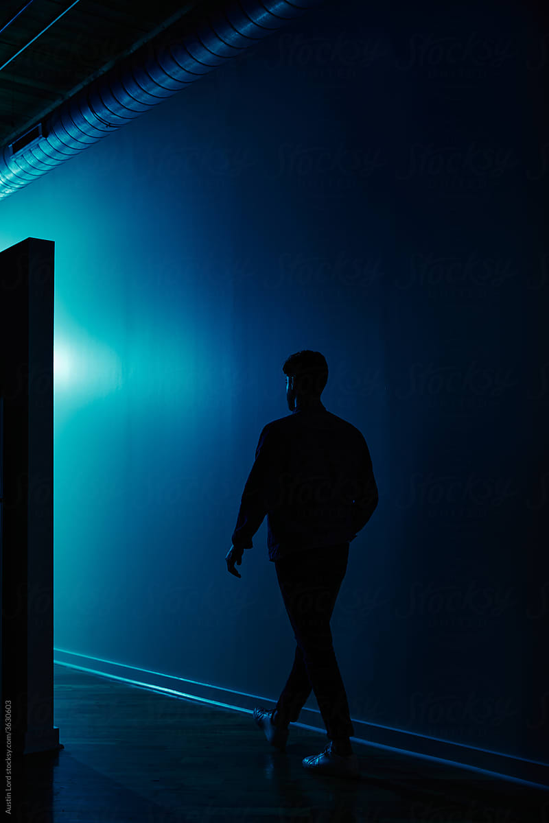 A man walking down a hallway