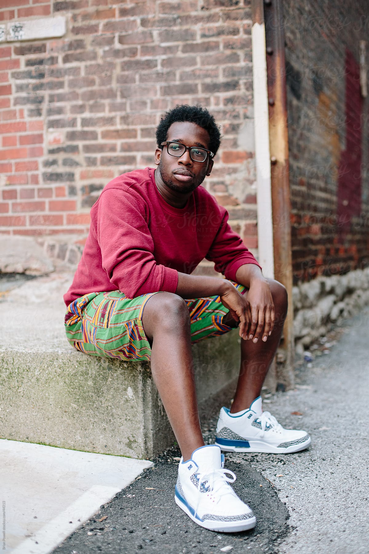 young Black man wearing glasses.