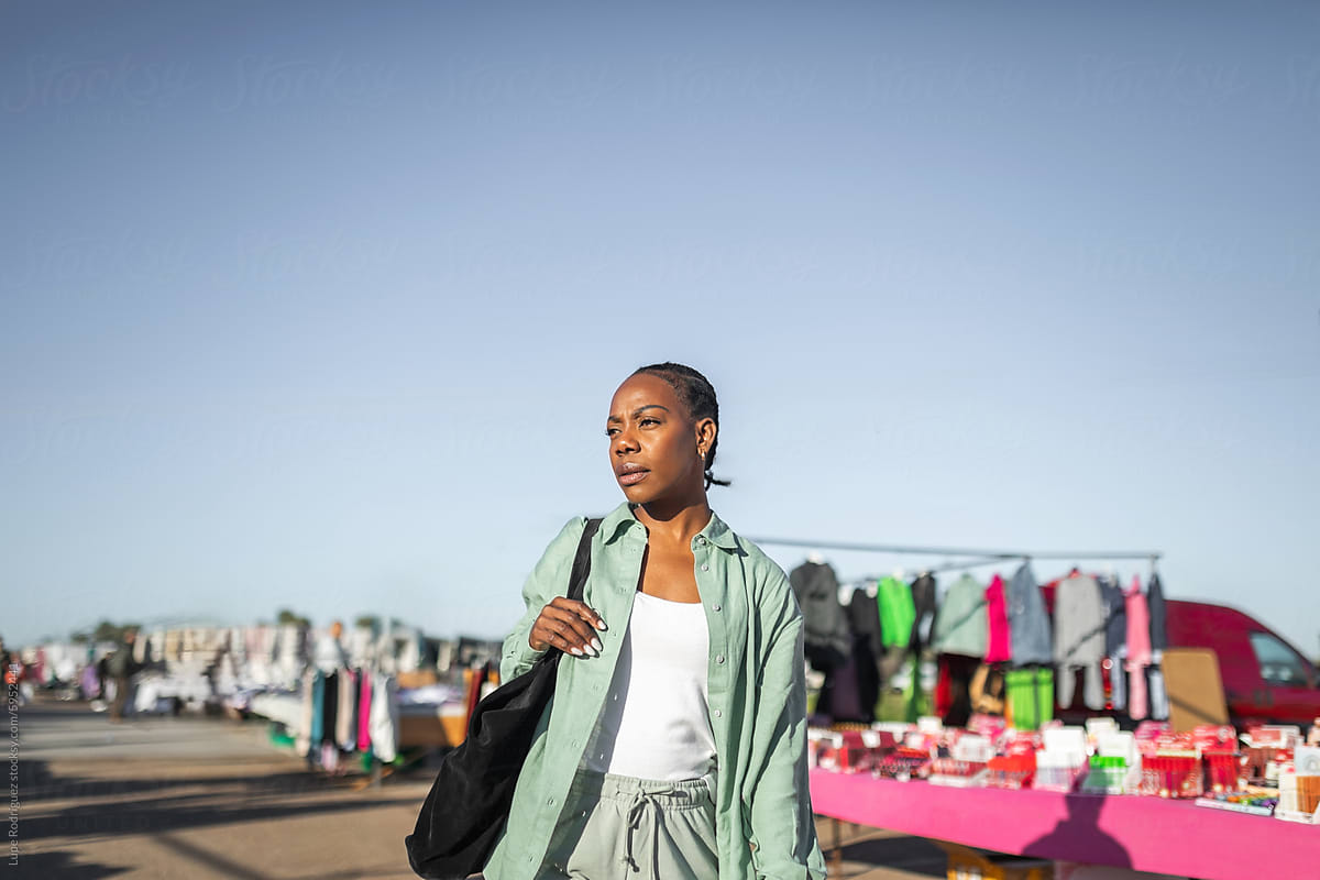 black woman buying clothes at a flea market