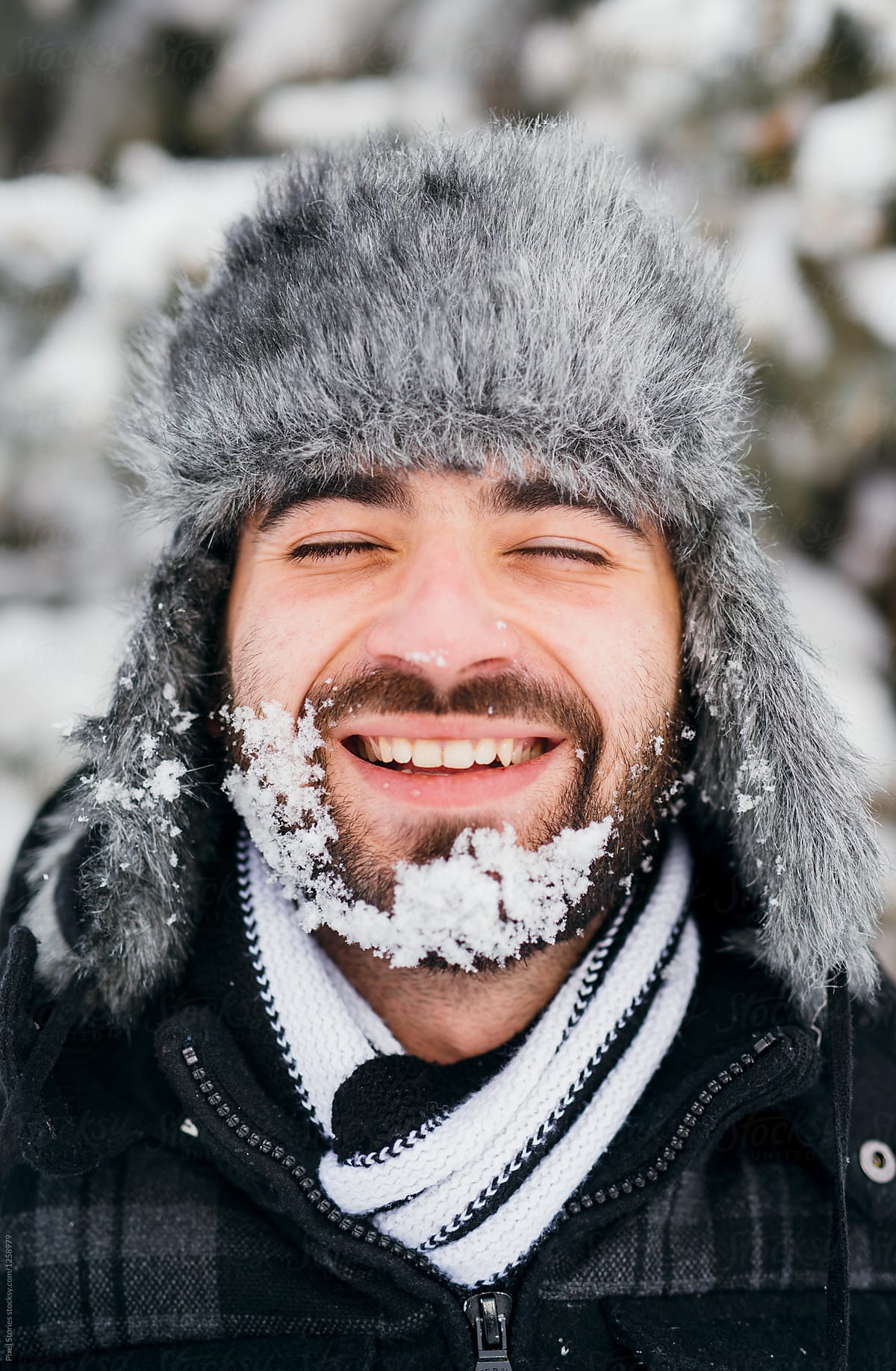 Young man smiling with snowy face