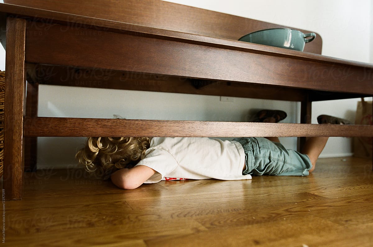 Boy Hides Under Bench In Home Del Colaborador De Stocksy Maria Manco Stocksy 0980