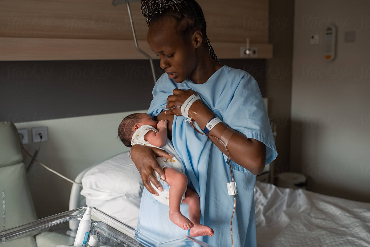 Concerned black mom breastfeeding baby