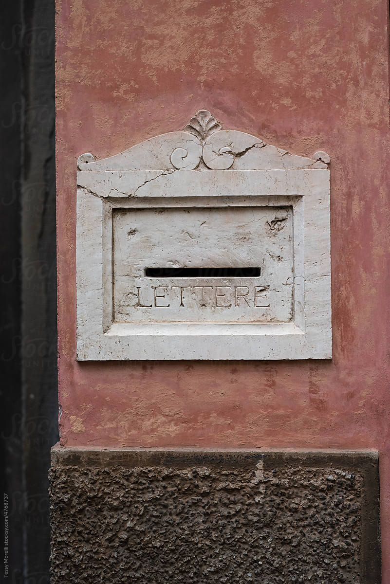 Italian letterbox in marble on pink wall