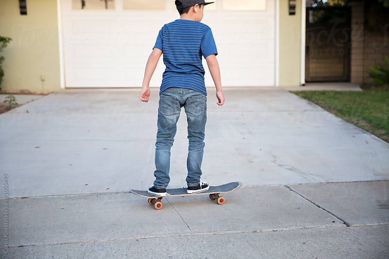Boy with hat riding his skateboard