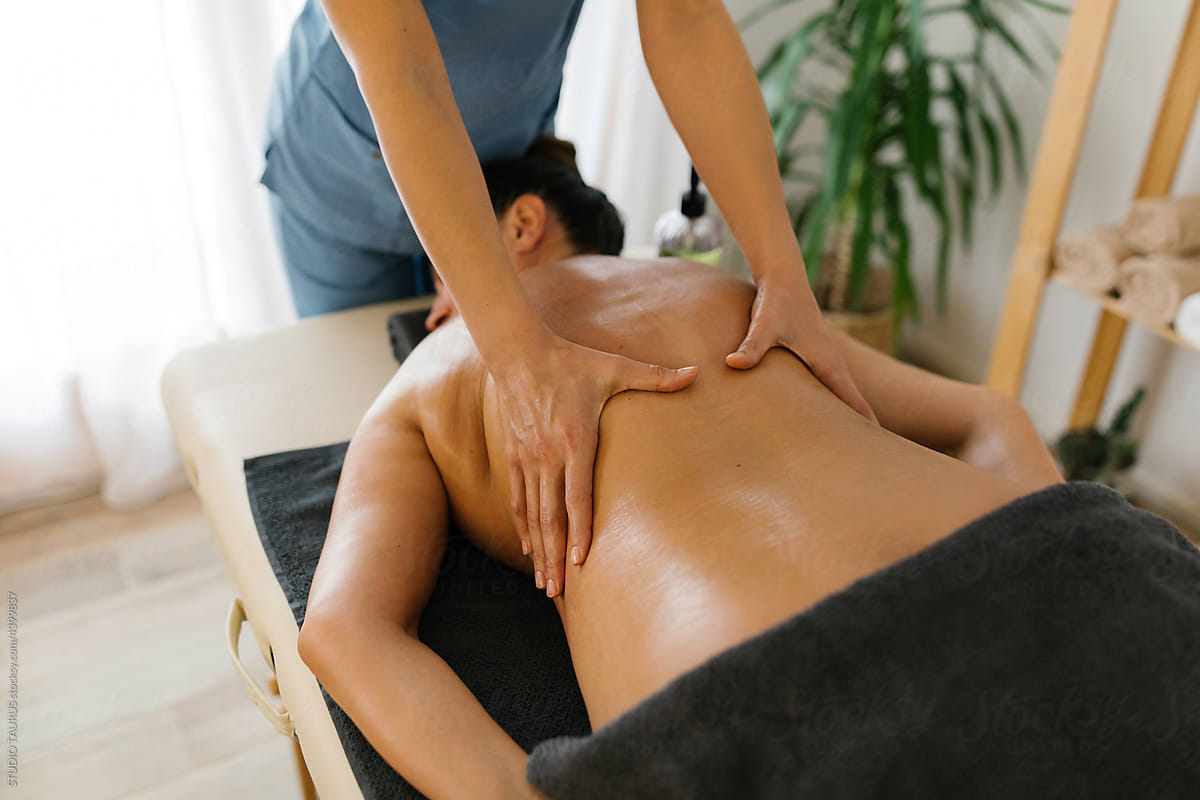 Female having massage at spa from massage therapist