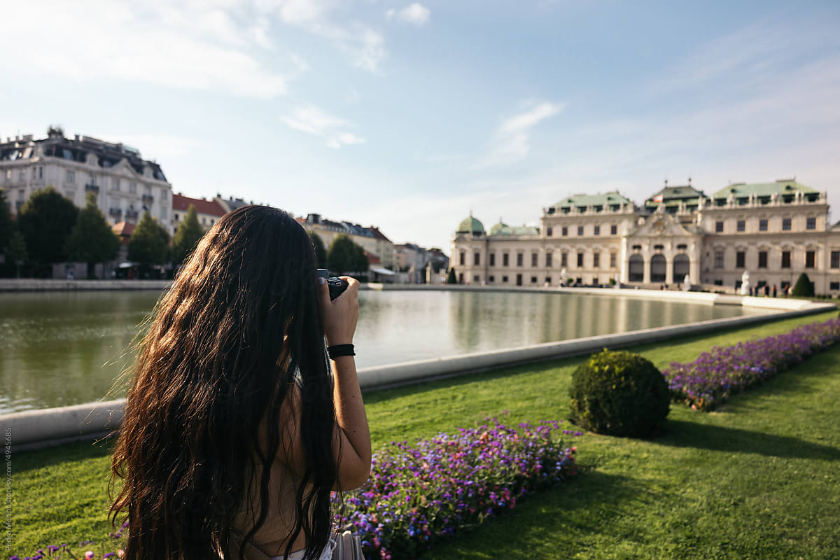 Woman taking photos at Belvedere Palace in Vienna