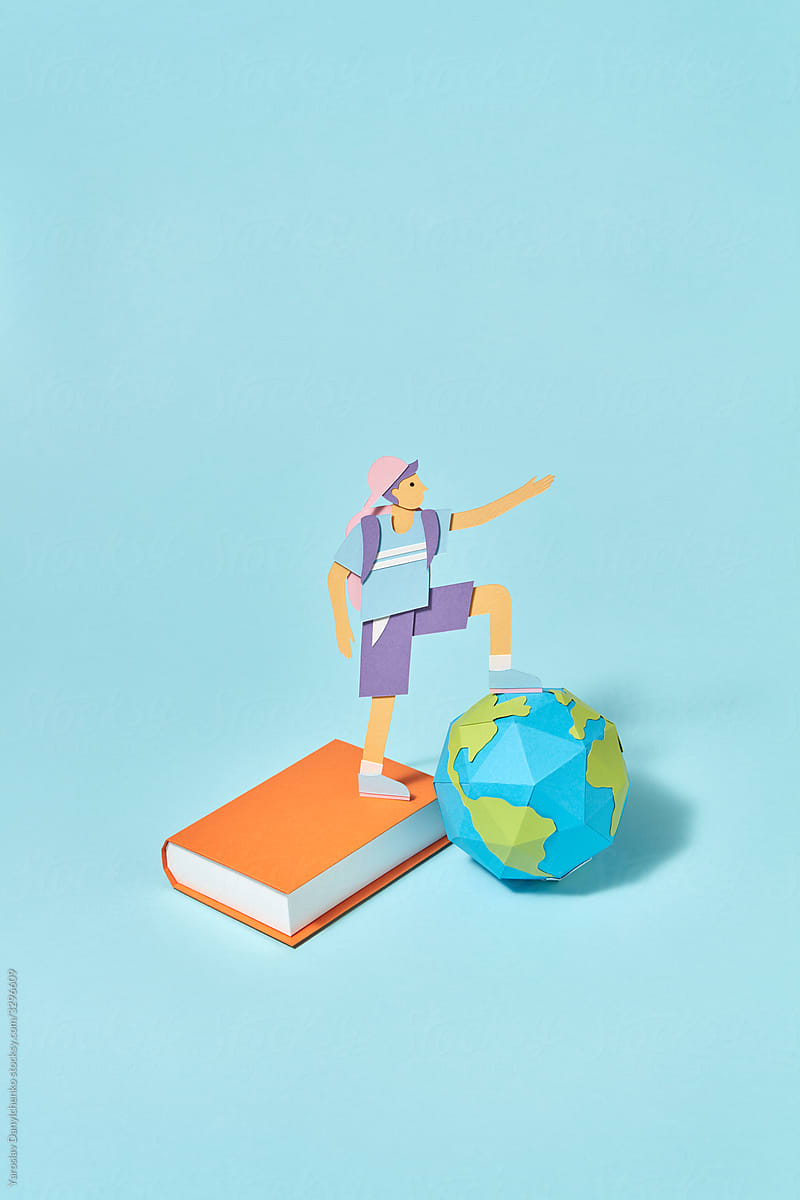 Papercraft schoolboy with paper book and globe.