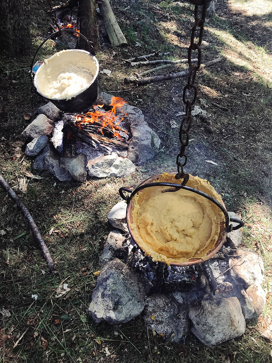 Italian polenta cooking on fire in a forest