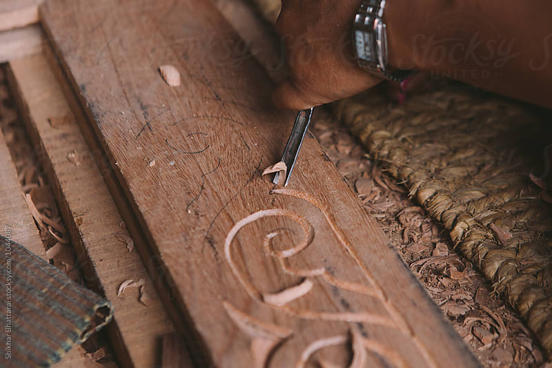Carving a wooden door frame.