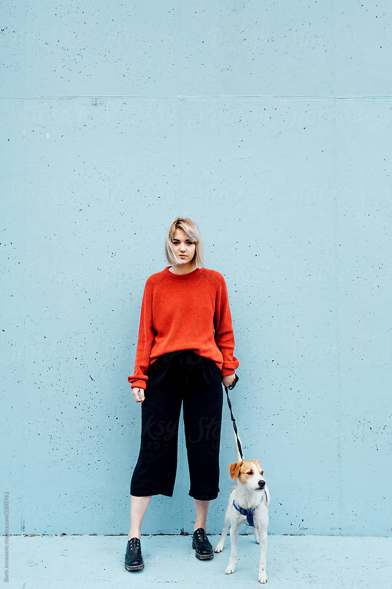 Portrait Of A Blonde Girl In Red Sweater With Her Dog