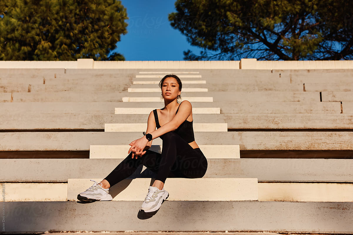 Female athlete sitting on steps