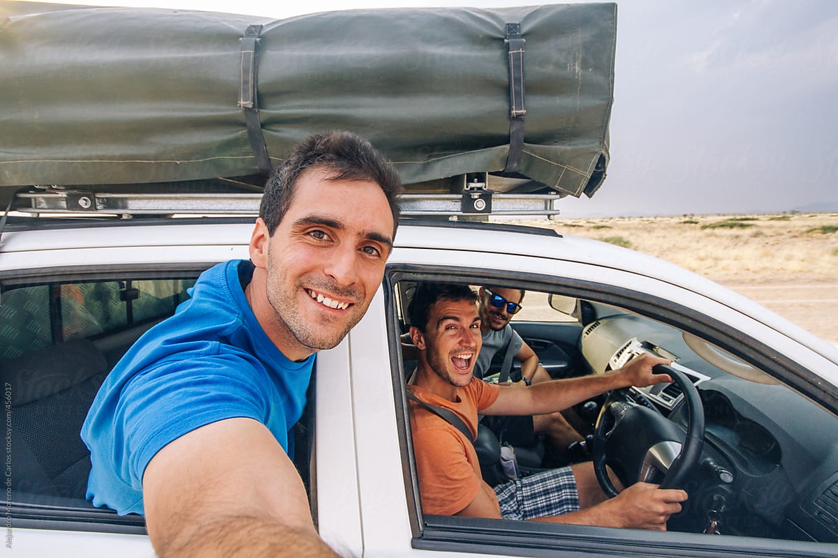 Selfie of friends traveling in off-road car