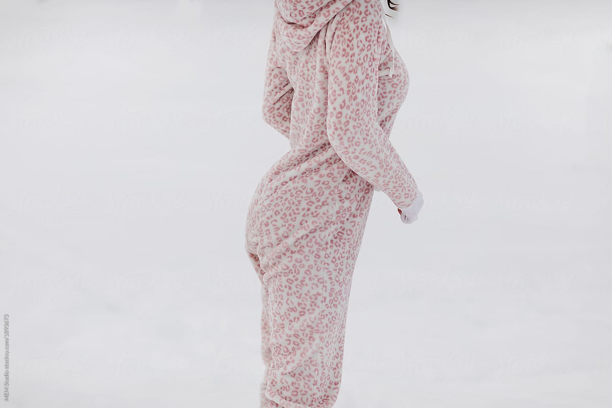 Beautiful woman in the snow wearing onesie