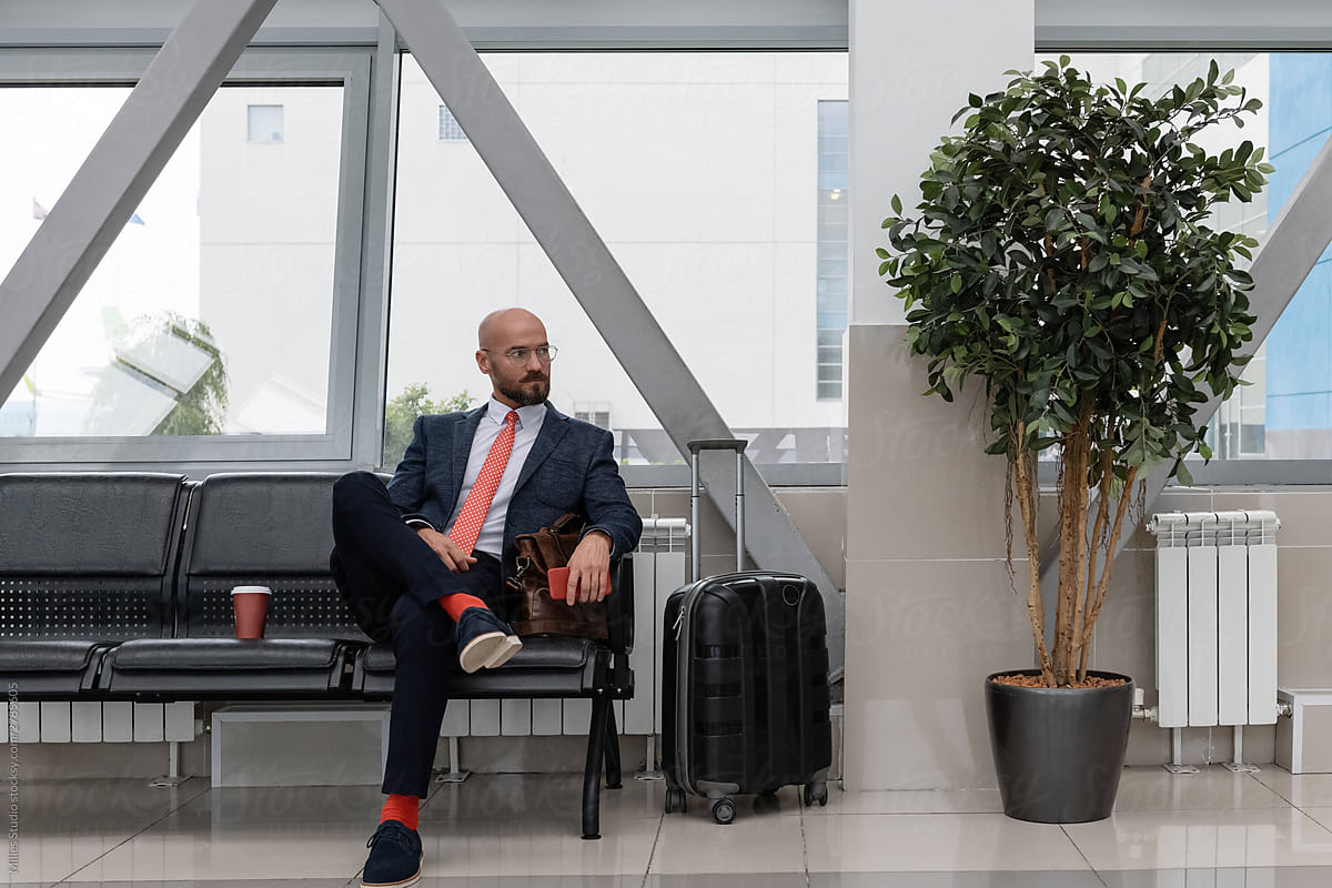 Relaxed boss waiting for flight in airport