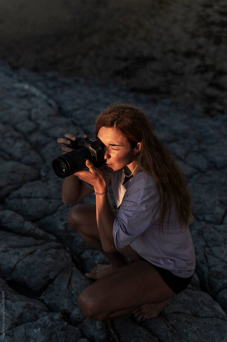 Woman photographer using digital camera