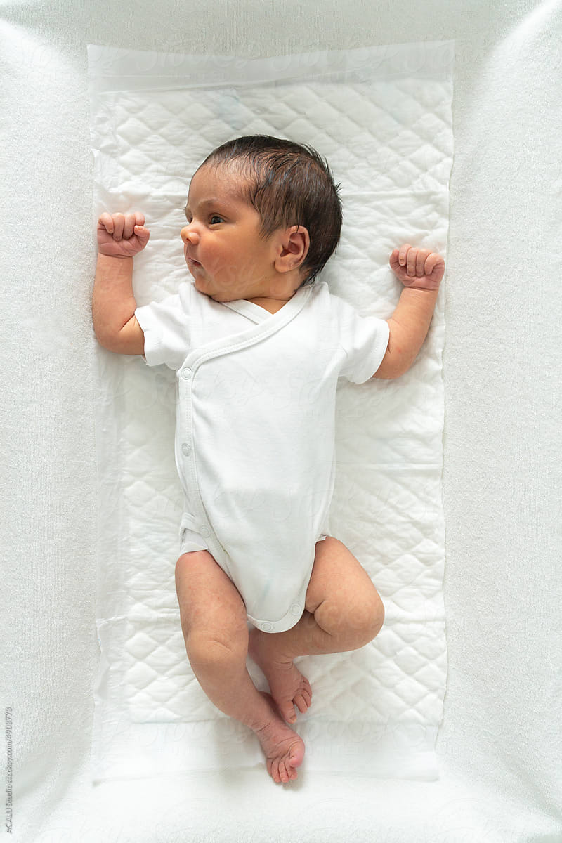 Top view of a portrait of a newborn on a crib