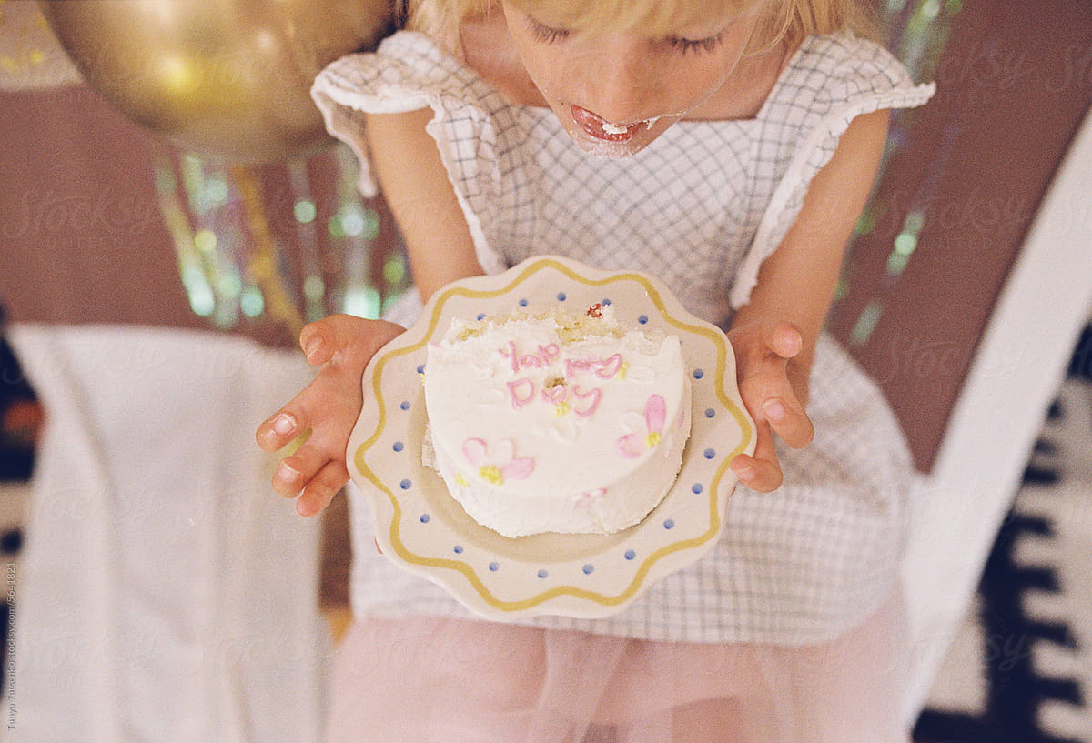 A birthday girl eating a cake