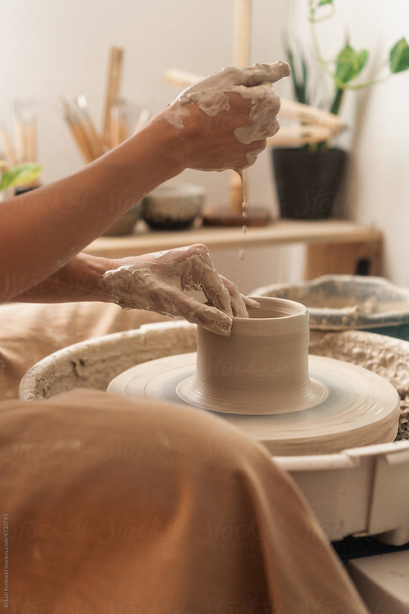 Potter Dripping Water On Clay On The Pottery Wheel