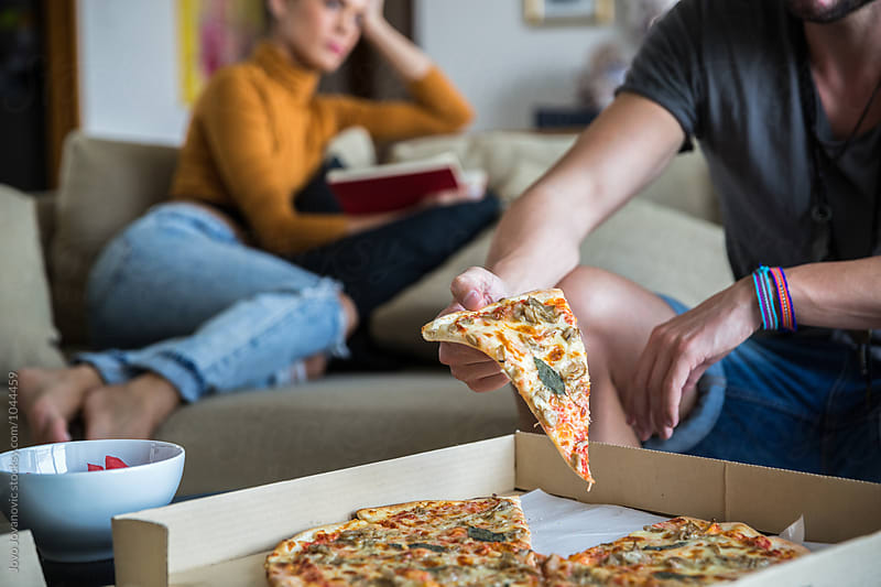 Couple at home having pizza for dinner