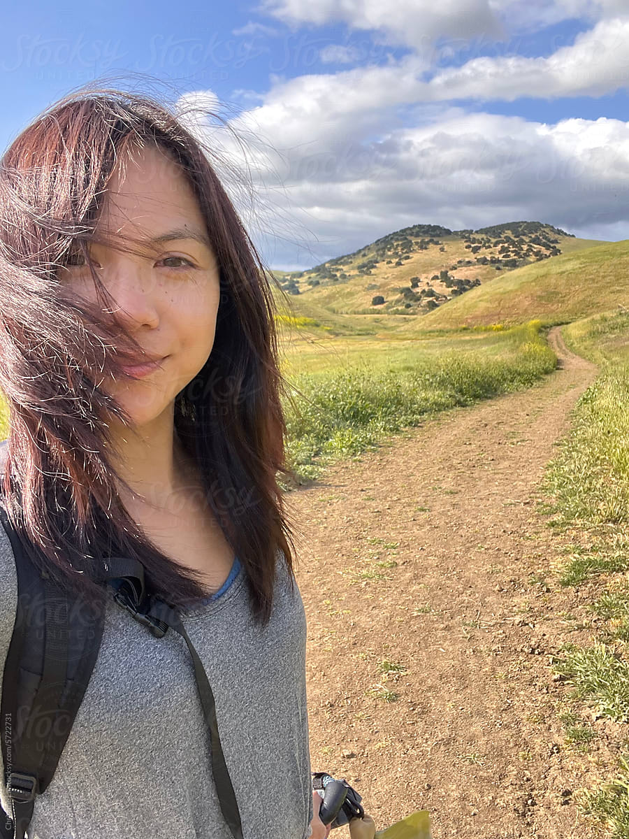 UGC selfie of smiling woman on a hike