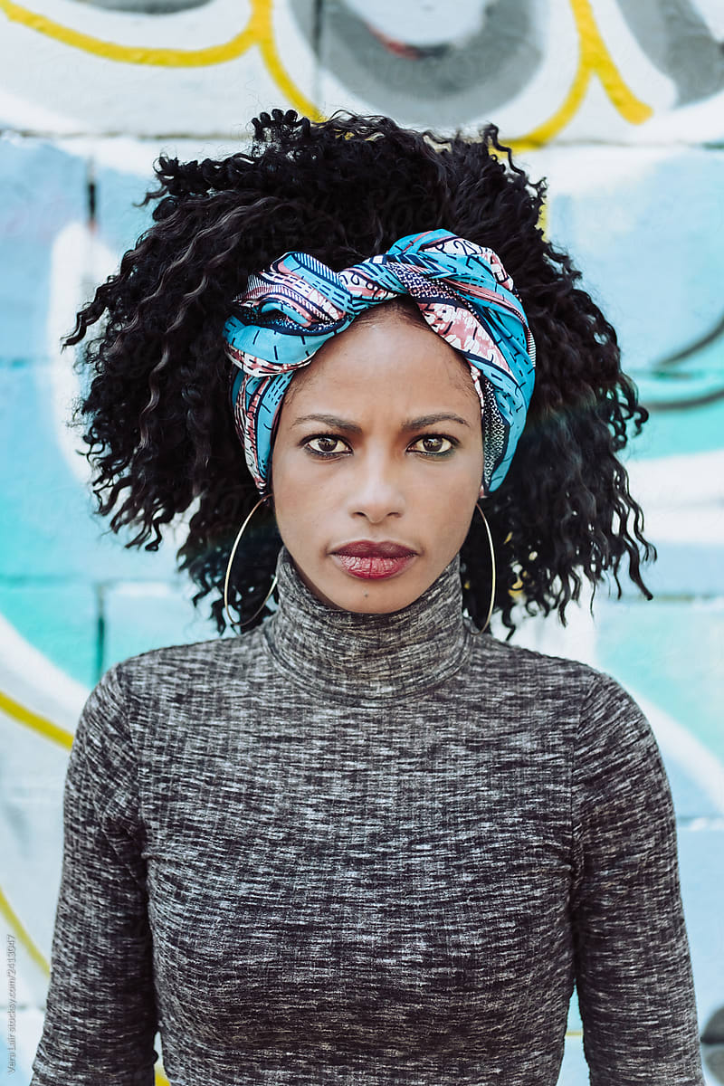 Beautiful Afro Woman in front of a blue wall
