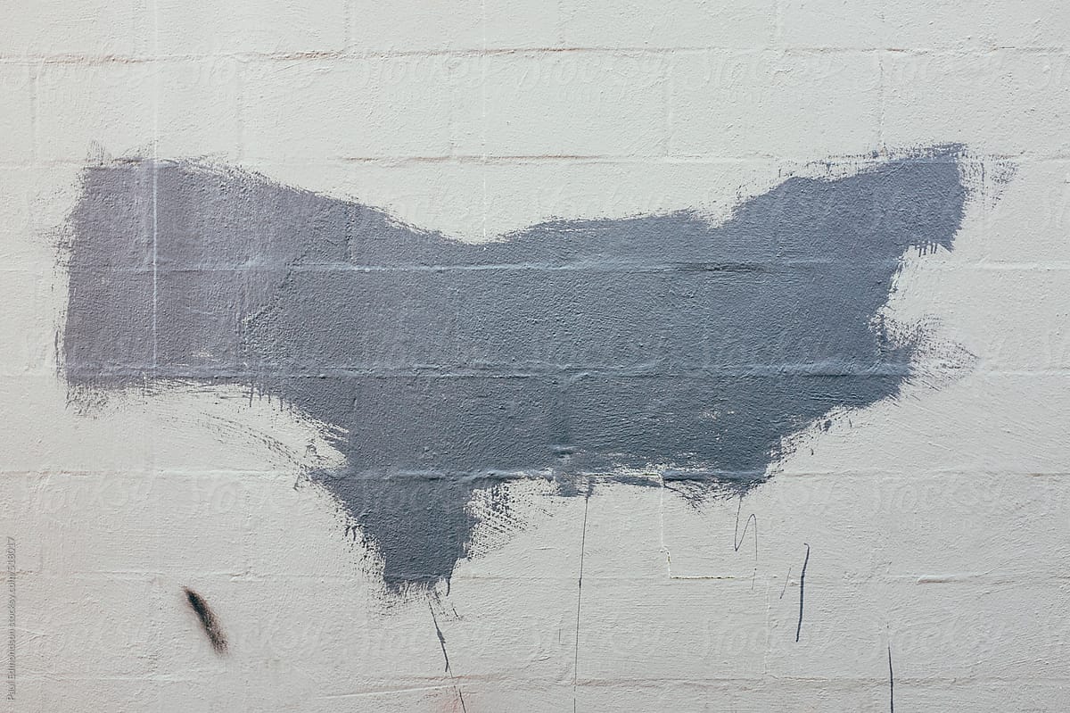 Gray paint on wall, covering graffiti tags